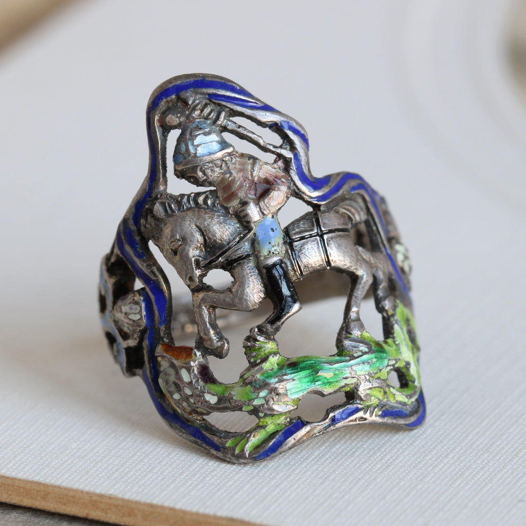 antique silver ring with slightly 3-d carved image of St. George slaying the dragon, accented with colored enamel