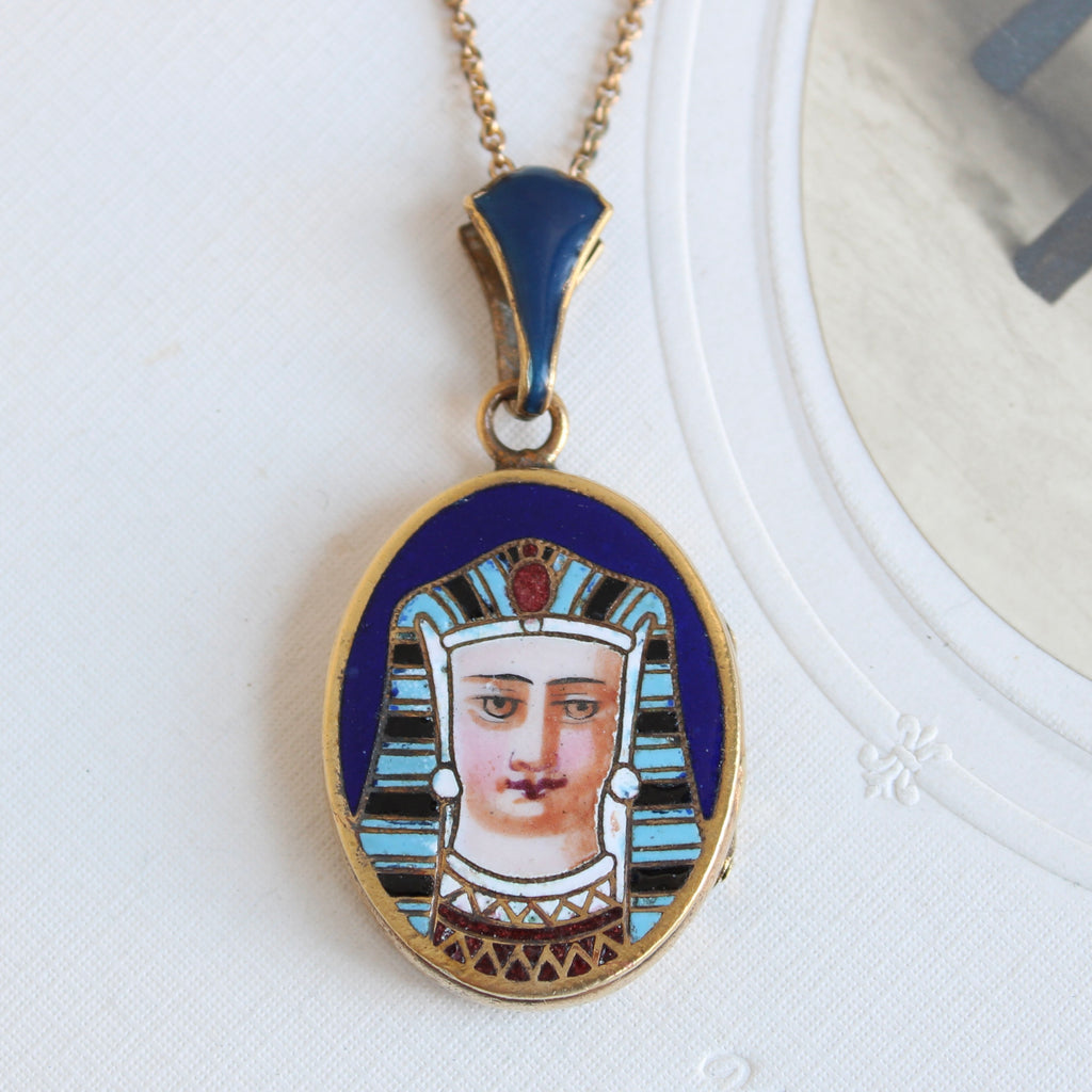 antique locket with enameled Egyptian pharaoh in a headdress on the front cover