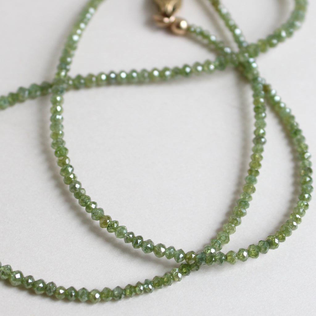 small green diamond beads with antique engraved gold lobster claw clasp