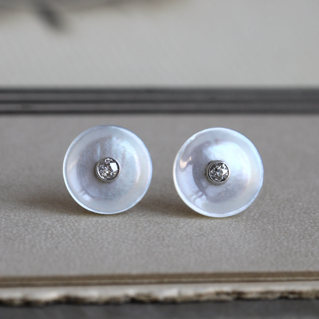 small round mother of pearl stud earrings with diamond centers