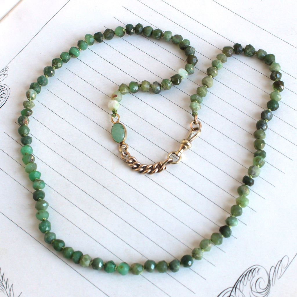 faceted green chrysoprase bead necklace with an attached 1" section of gold curb chain and a carved green scarab connector, dog clip clasp that can gold pendants
