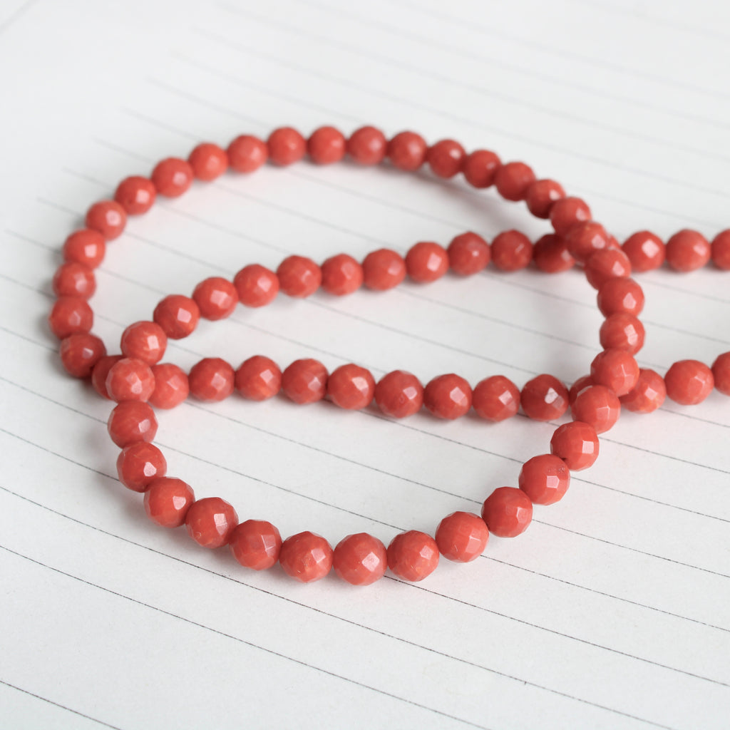 Handmade beaded necklace with faceted red coral round beads with a 14k vintage charm clasp closure.
