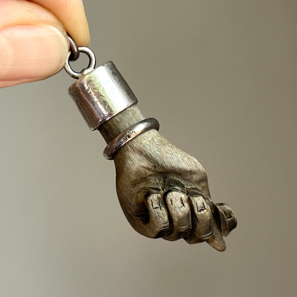 Vintage pendant with a wooden carved hand with a sterling silver bracelet and bail