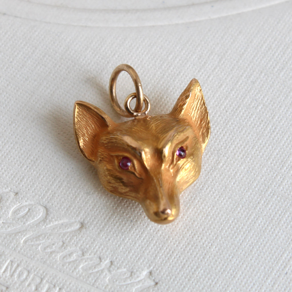 yellow gold 3-dimensional fox head charm with garnet eyes