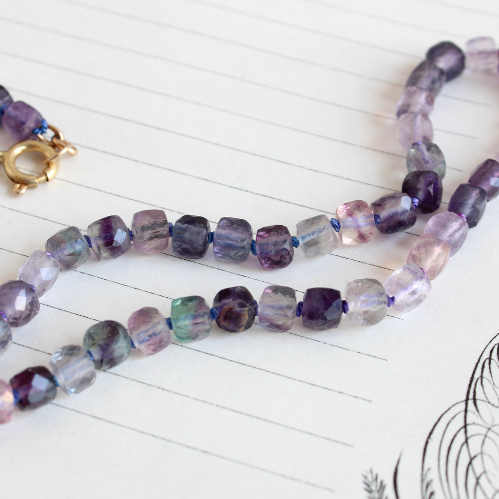 translucent purple, pink and aquamarine cube-cut fluorite beads knotted on silk with a 14k clasp