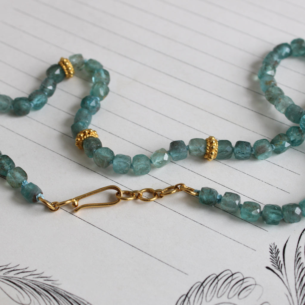 cube cut copper aquamarine beads knotted on teal silk with 22k spacer beads and a 22k hook clasp