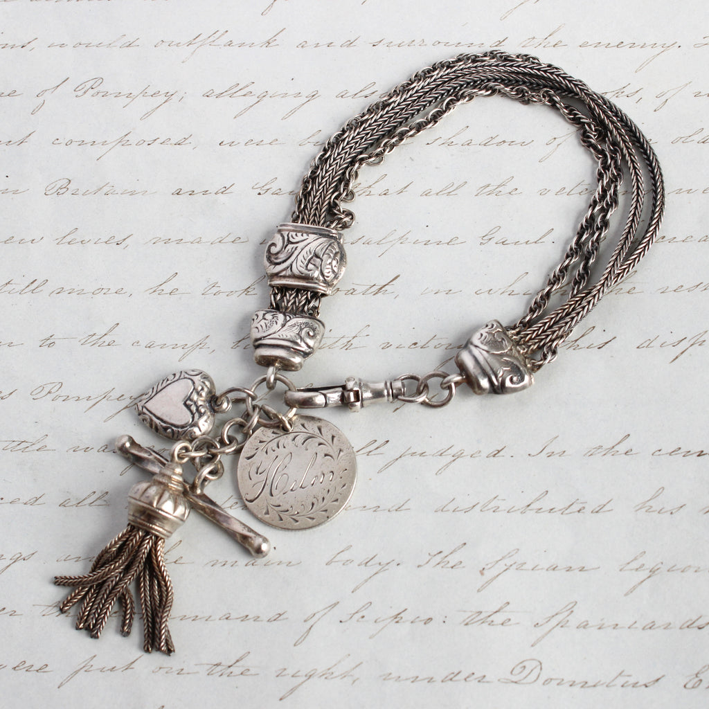 antique sterling silver watch chain charm bracelet with a charm engraved "helen", a sterling tassel, and a small sterling puffy heart charm