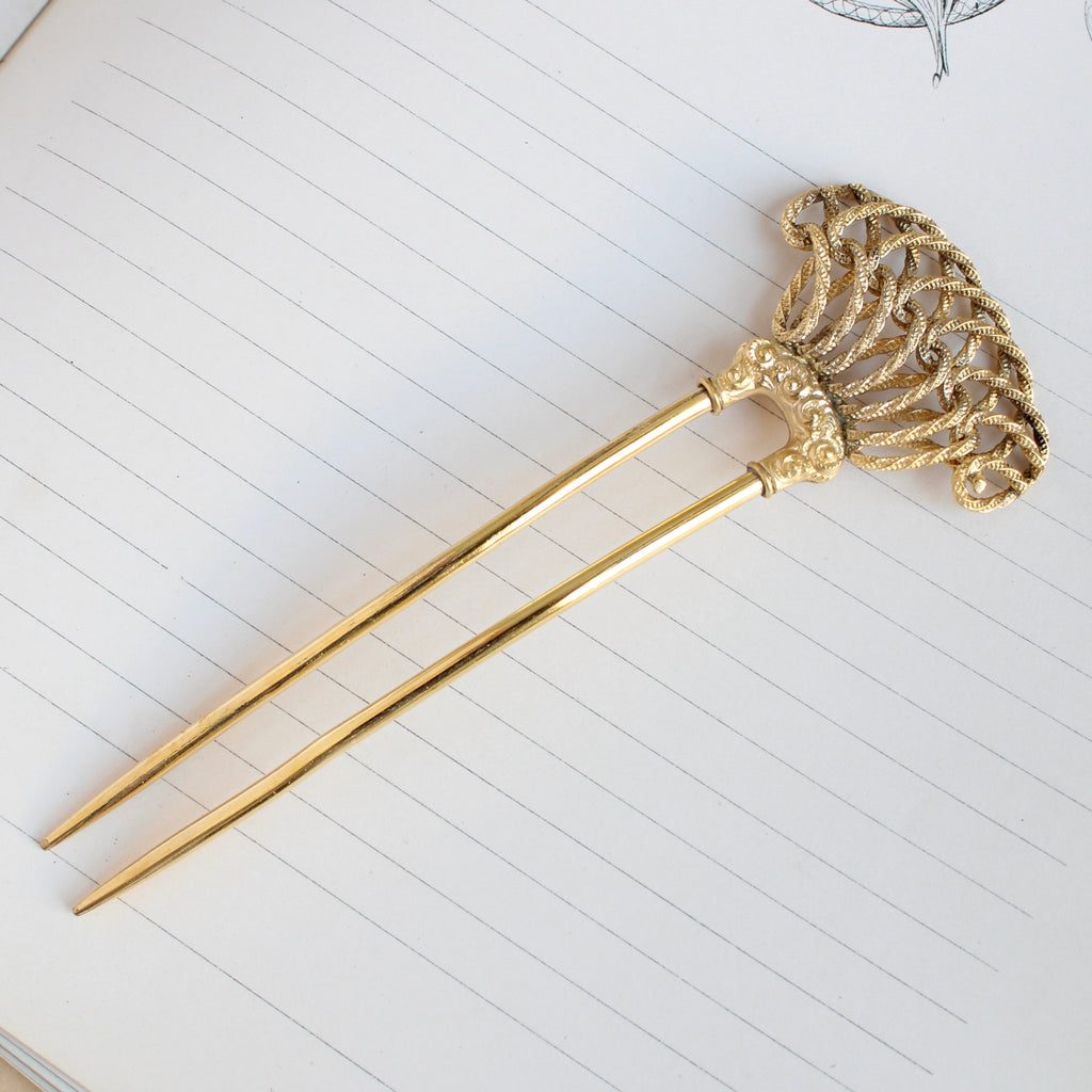 antique hair comb in yellow gold plate with heart shaped love knot design at the top