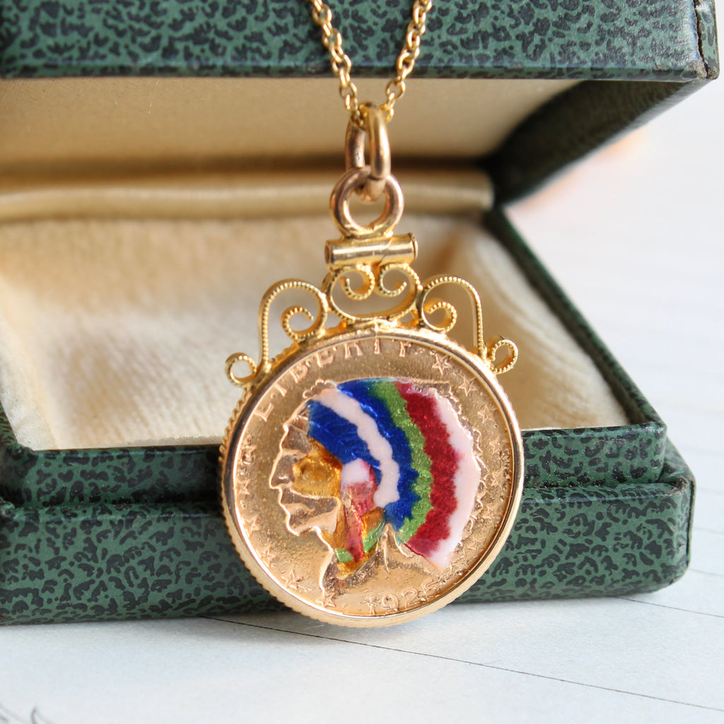 gold coin pendant from 1925 with indian head design and colorful enamel details
