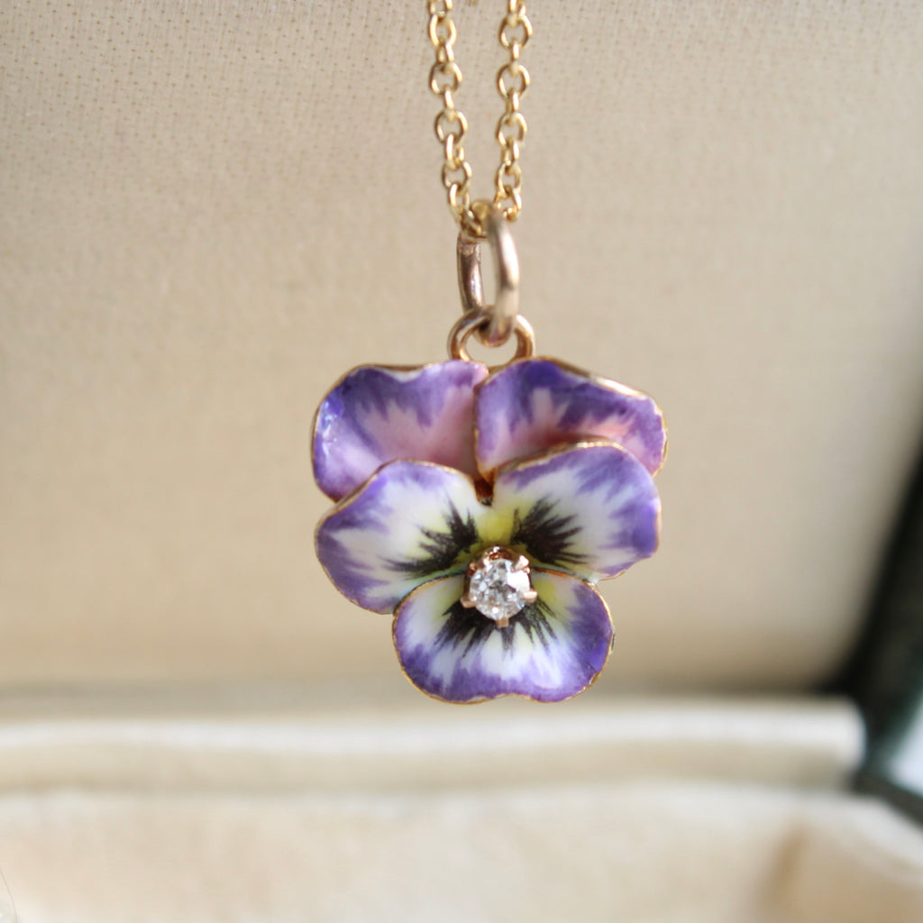 miniature pansy charm in 14k with pink, purple and white enamel and a diamond in the center