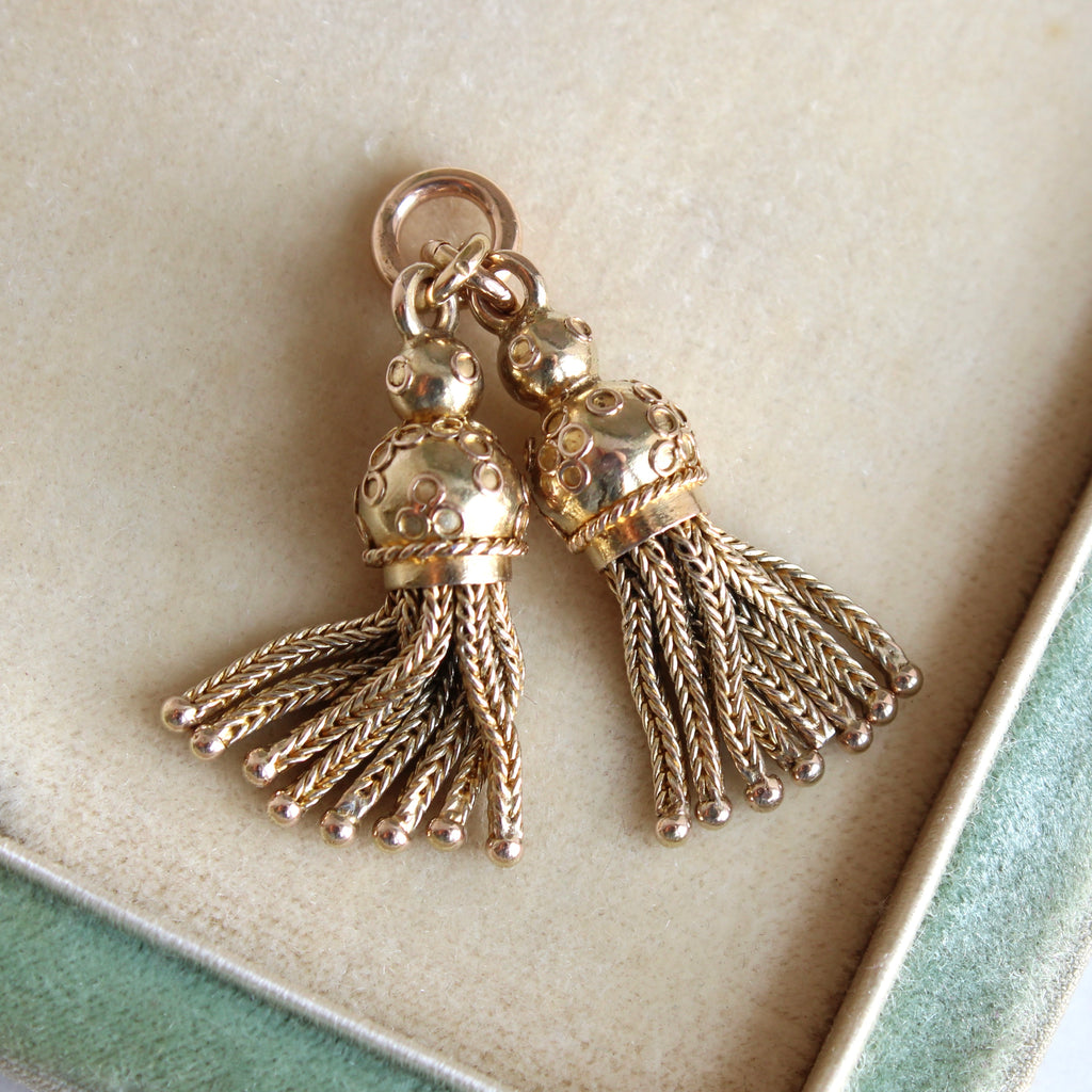 a pair of miniature yellow gold tassels