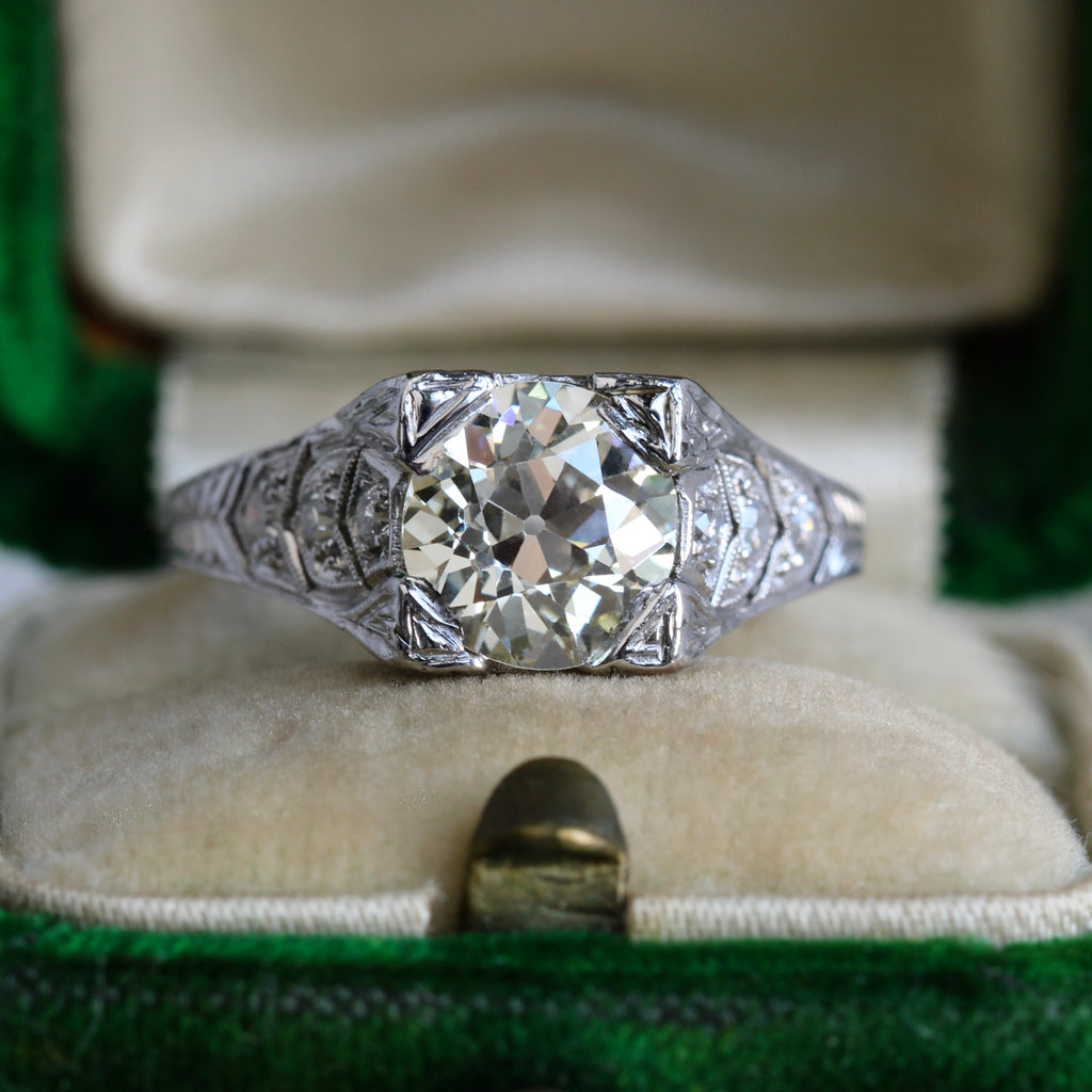 large antique cut diamond ring in a platinum mounting with pierced work and engraved details