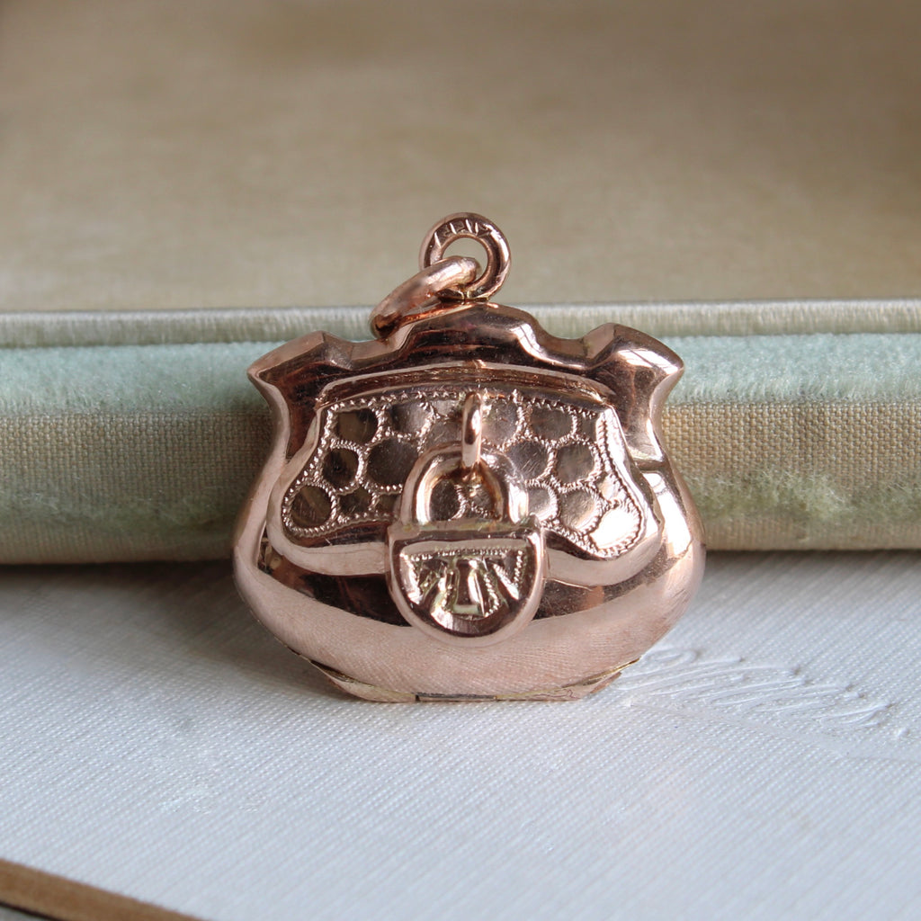 small locket in rose gold designed to look like an antique coin purse