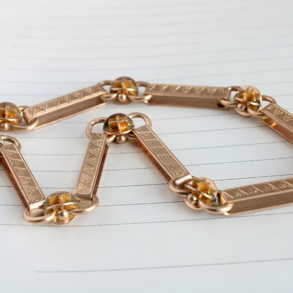 antique yellow gold watch chain with bar and ball links with triangle etching.