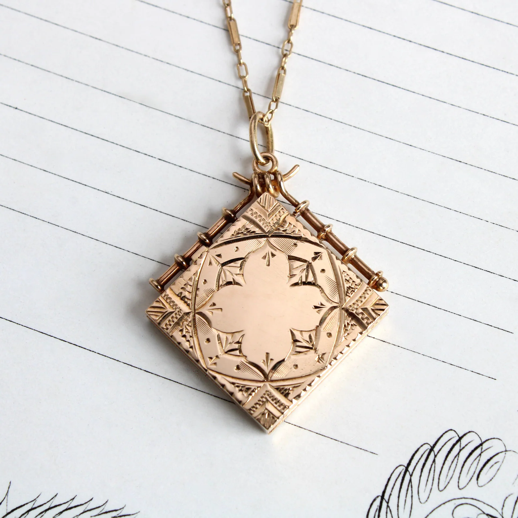 Antique 14k yellow gold square locket with a delicate hand carved design on the front and back.