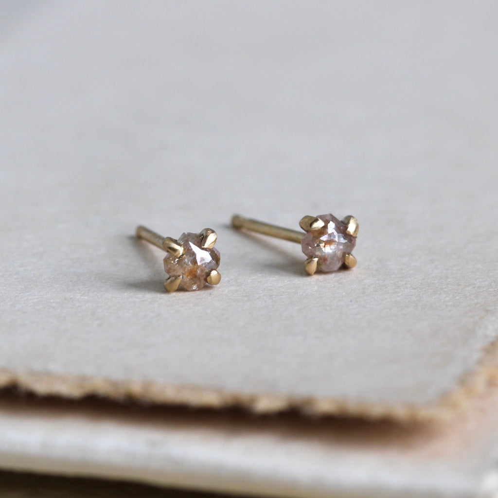 Yellow gold mismatched studs with fancy color rose-cut dainty diamonds.