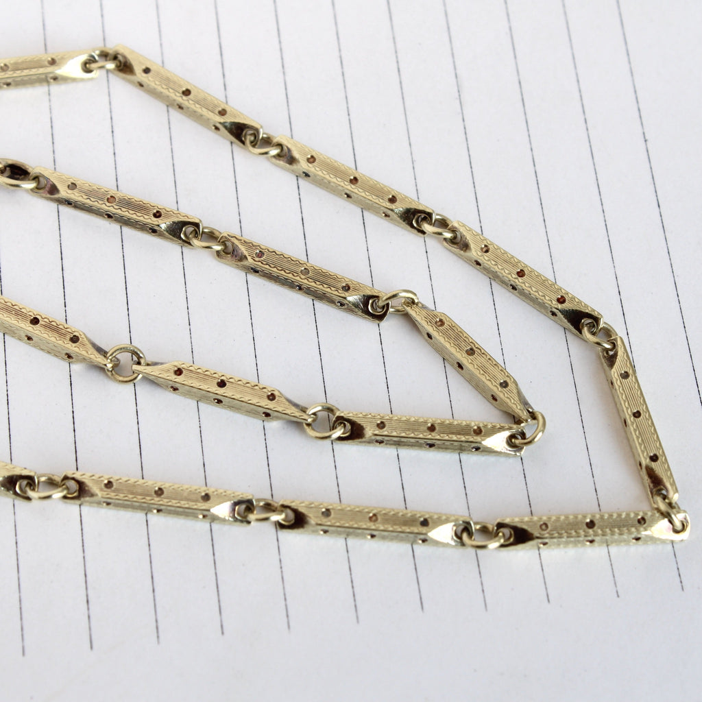 Antique yellow gold decorative link chain with watch clip charm and spring clasp closure.