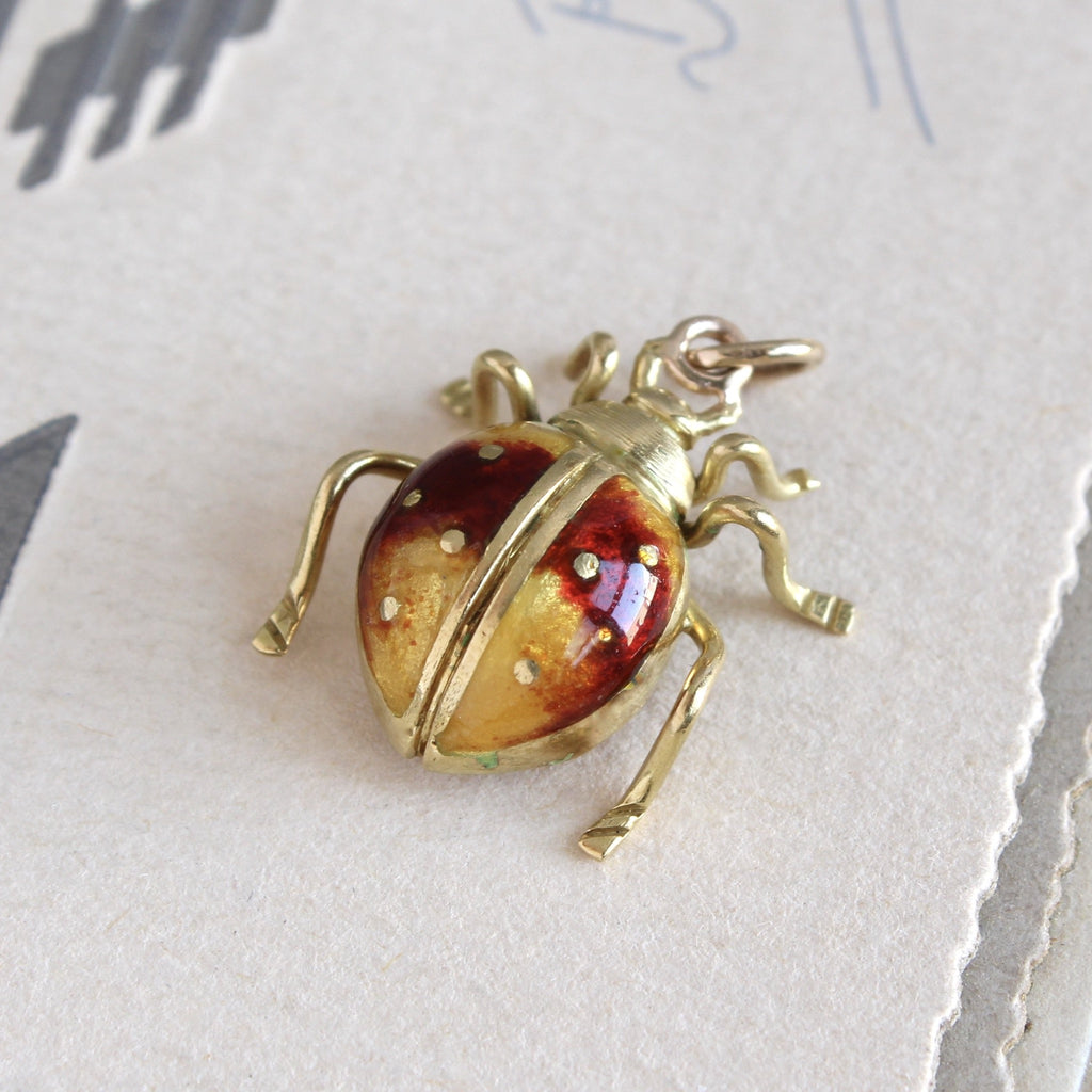 Vintage yellow gold and yellow and red enamel insect charm pendant.