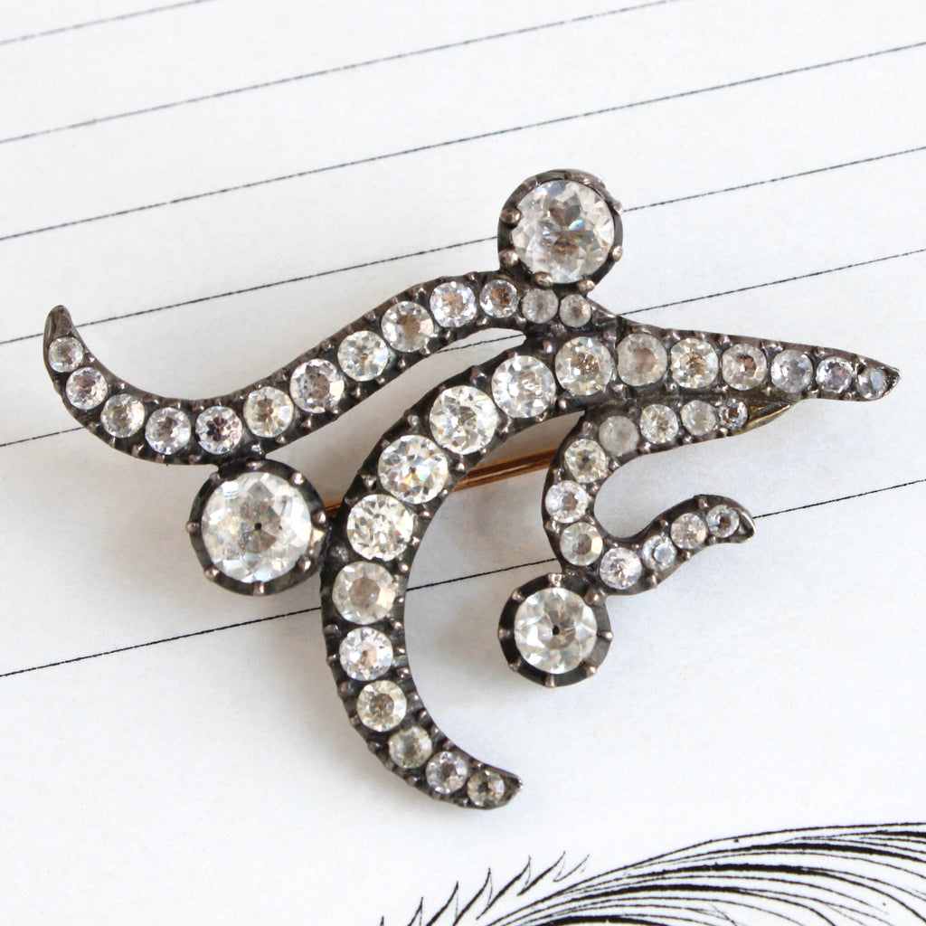 Sterling silver brooche in a flower design set with diamond-like paste gems.
