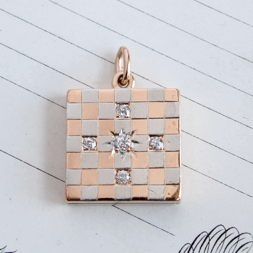 Antique two toned square locket with a checkered pattern that alternates white gold and yellow gold with five diamonds set in the center. 