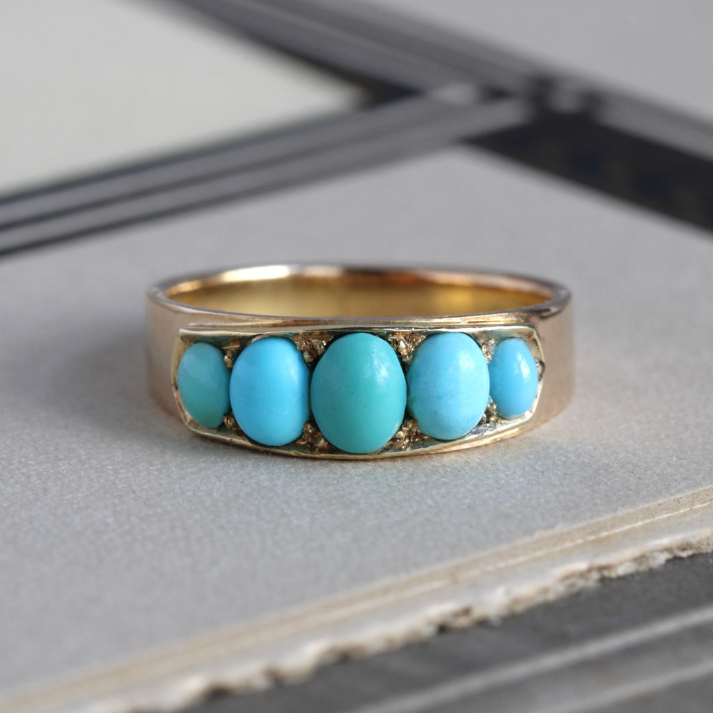 Antique yellow gold ring set with five blue turquoise cabochons.