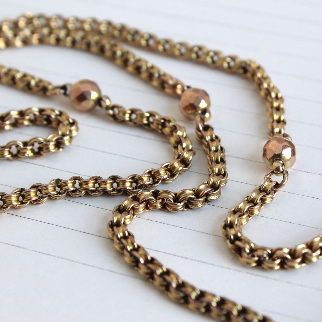 Antique 9k Yellow Gold cage link chain with rose gold faceted satellite beads throughout it.
