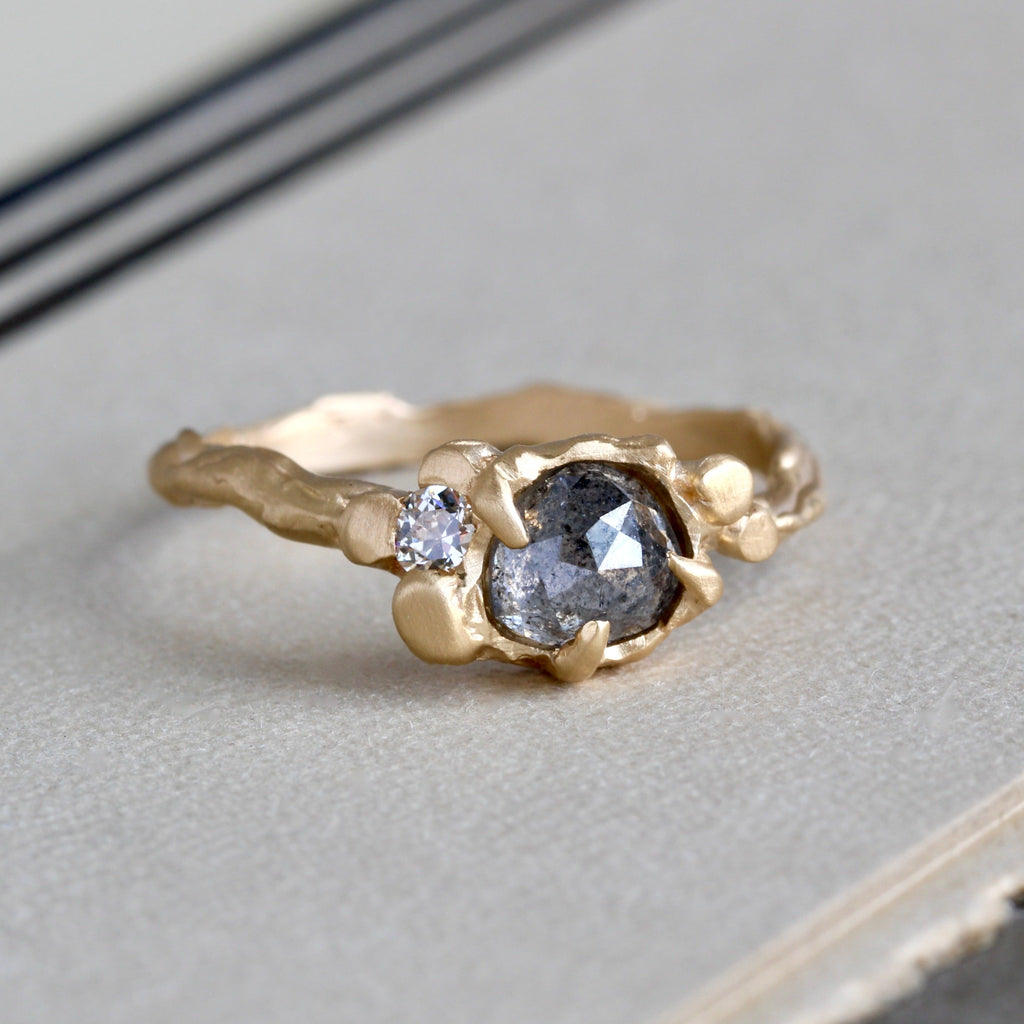 Handmade branch style yellow gold ring with a translucent  grey salt and pepper rose cut diamond accented by a white diamond