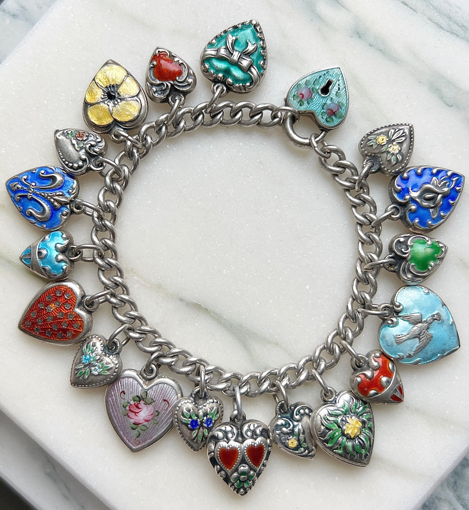 antique sterling bracelet with a colorful collection of enameled puffy heart charms