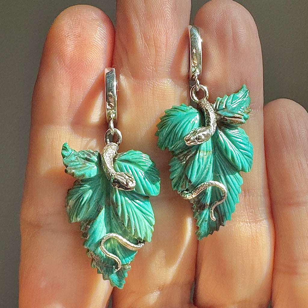 Turquoise leaves with silver snakes curled around on silver hoops