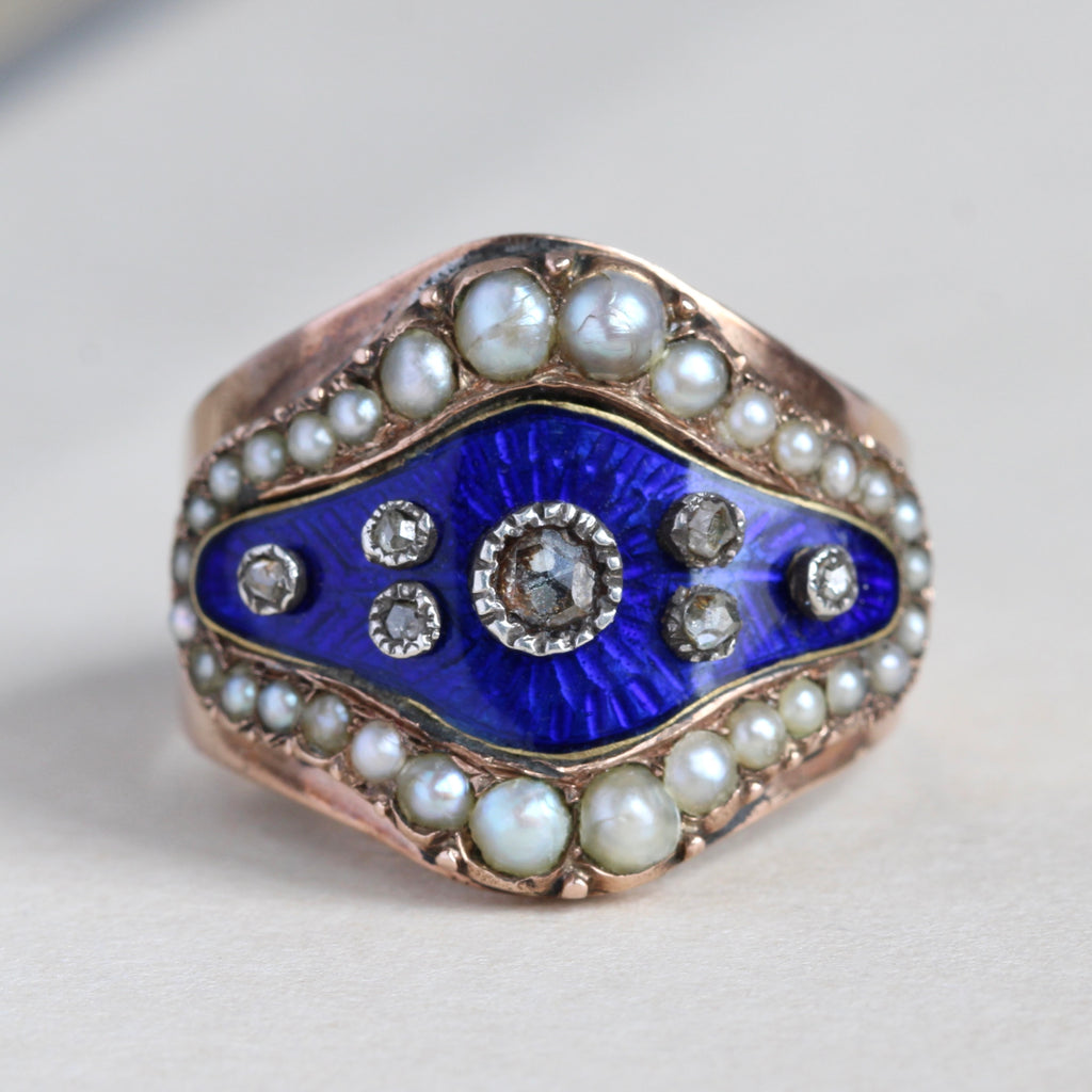 georgian gold ring with bright blue enamel set with rose cut diamonds in silver bezels and a border of pearls