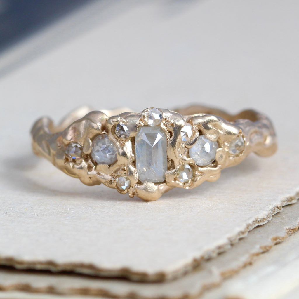 hand hammered yellow gold ring set with opalesecent white rose cut diamond in a branch style