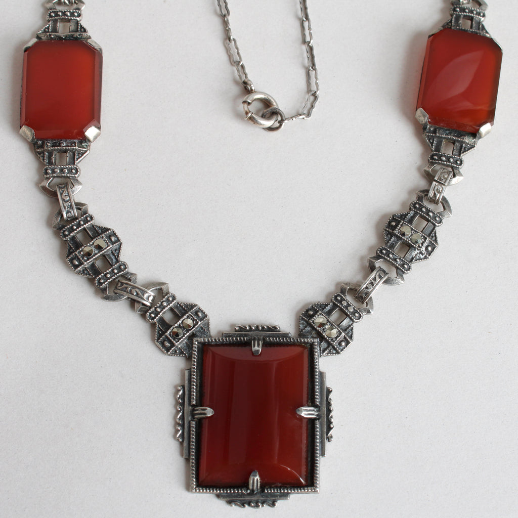 Art deco sterling silver necklace set with rectangualr cabochon carnelian and marcasite cabochons.