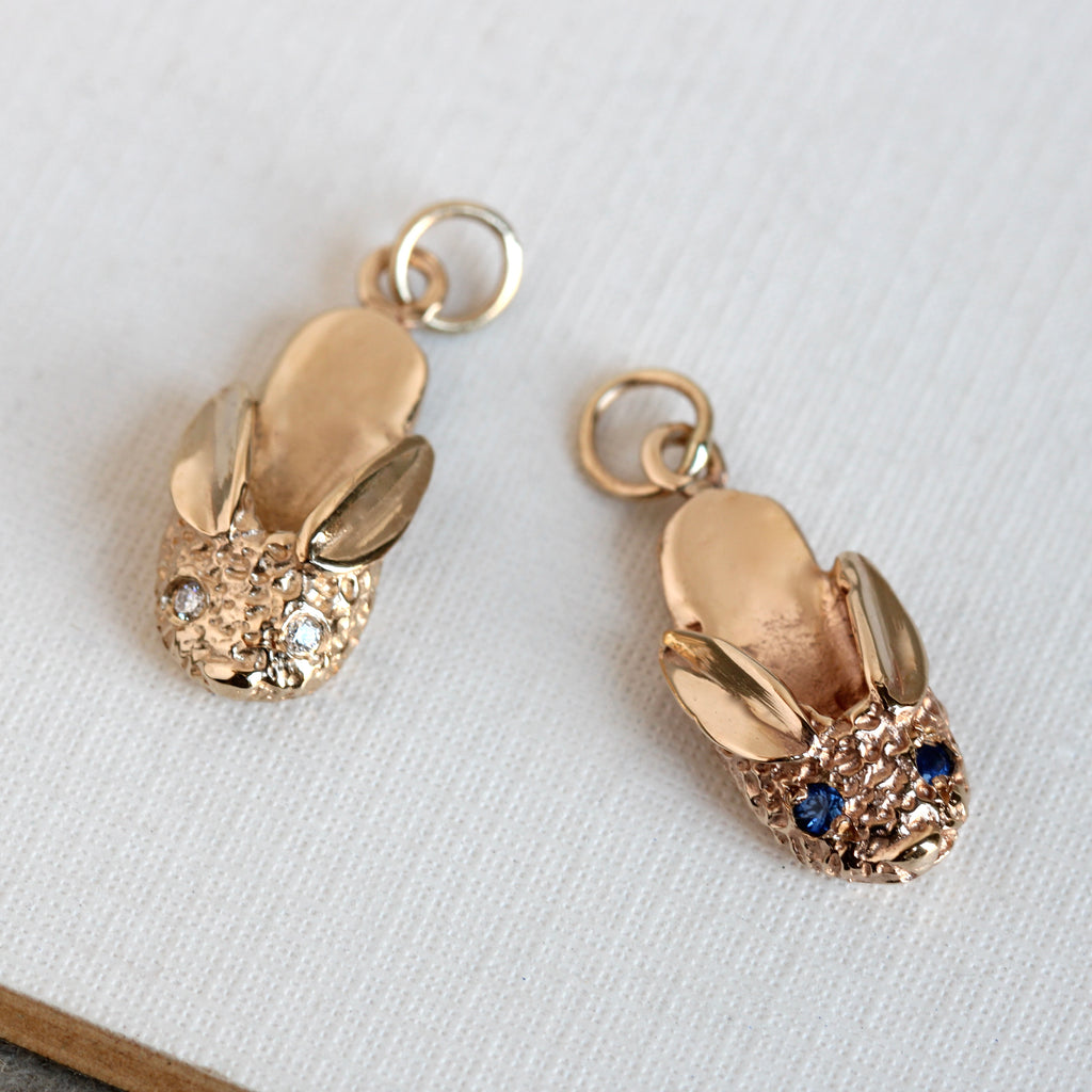 yellow gold bunny slipper charm with either diamond eyes or blue sapphire eyes.