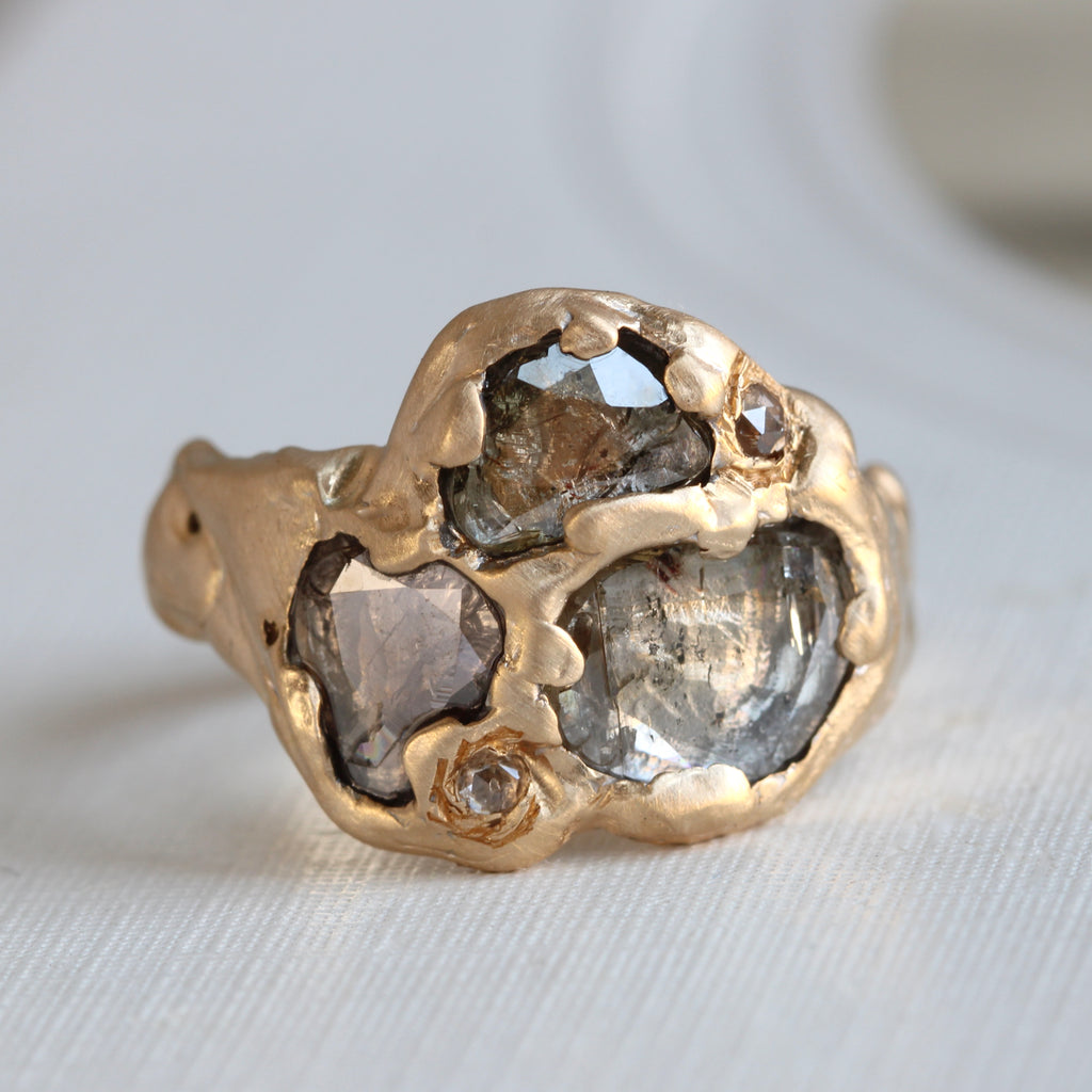 yellow gold ring with 3 large rose cut diamonds set pave style with a hammered matte finish