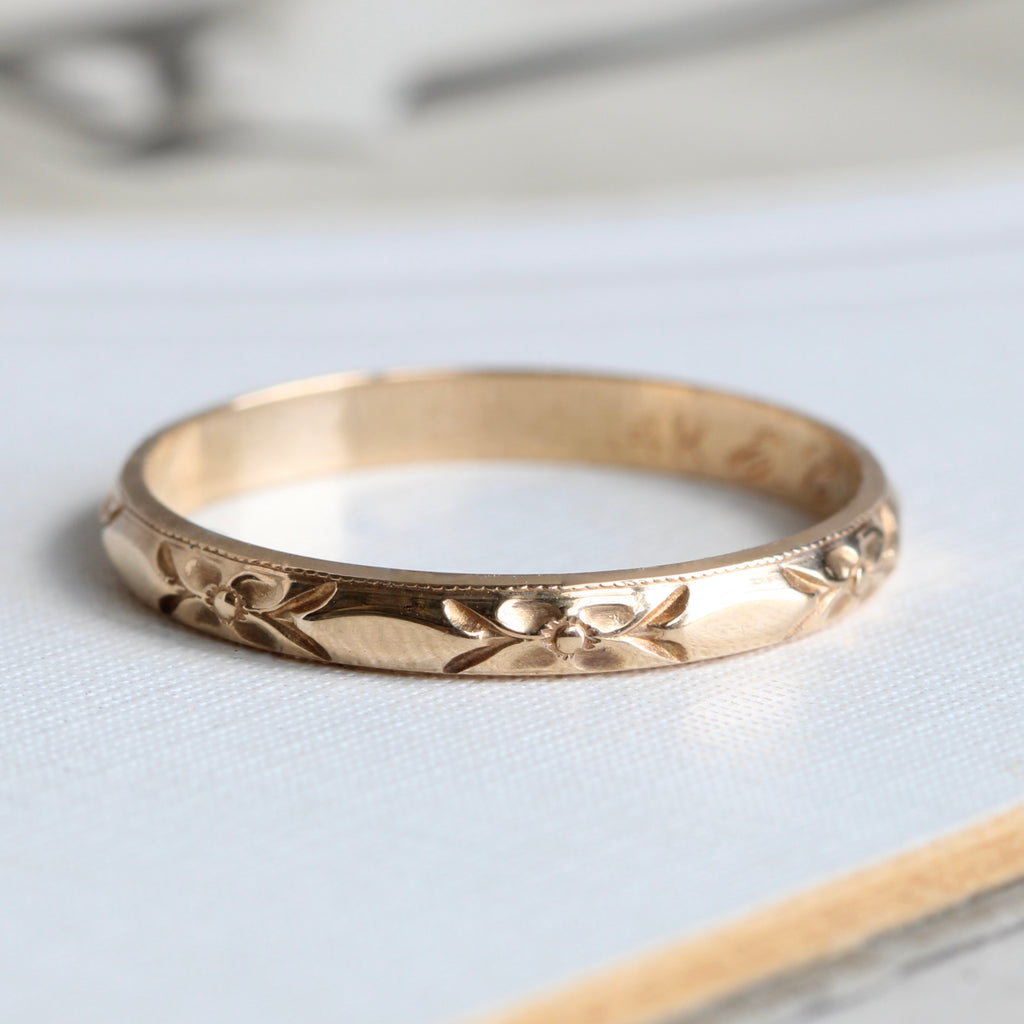 yellow gold band chased around the outside with an orange blossom flower design