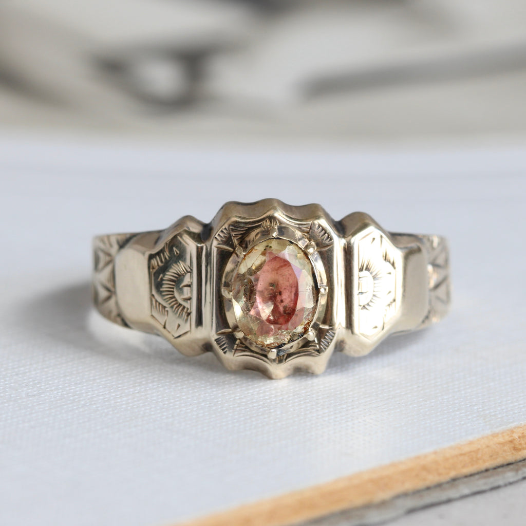 yellow gold ring set with a yellow citrine that has a pink foil backing to create a two color effect in the stone