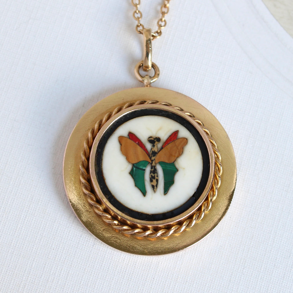miniature butterfly mosaic pendant made from colorful pieces of marble in a gold setting