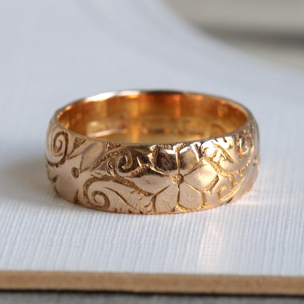 very deep yellow gold band engraved all around in a floral pattern, letter dated 1906