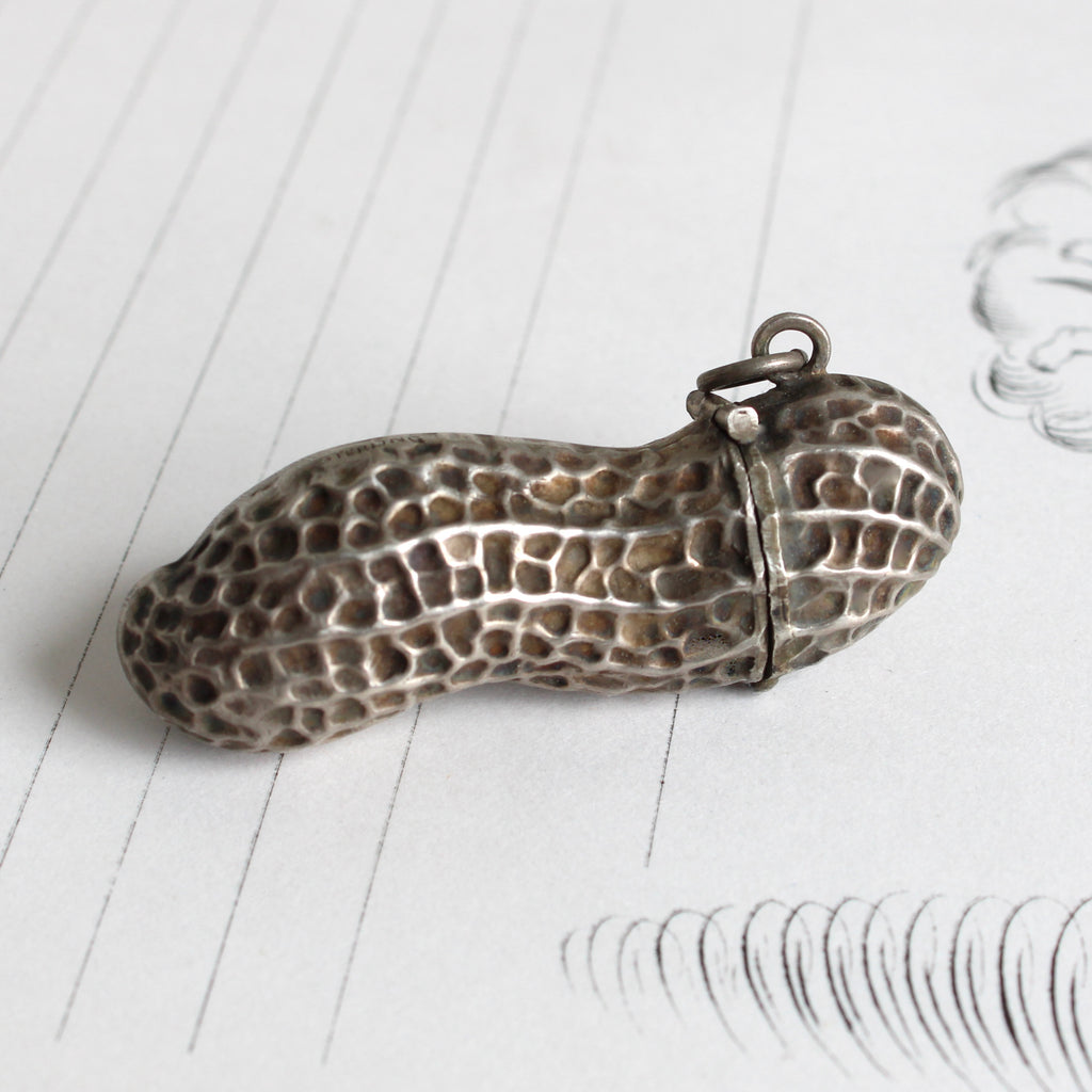 silver peanut pendant with realistic details that opens to a perfumer with a lid