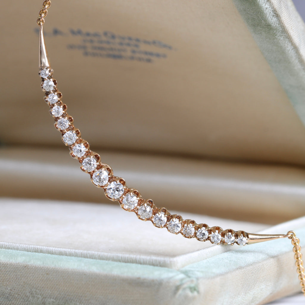 yellow gold necklace of very bright old cut diamonds set in a crescent moon