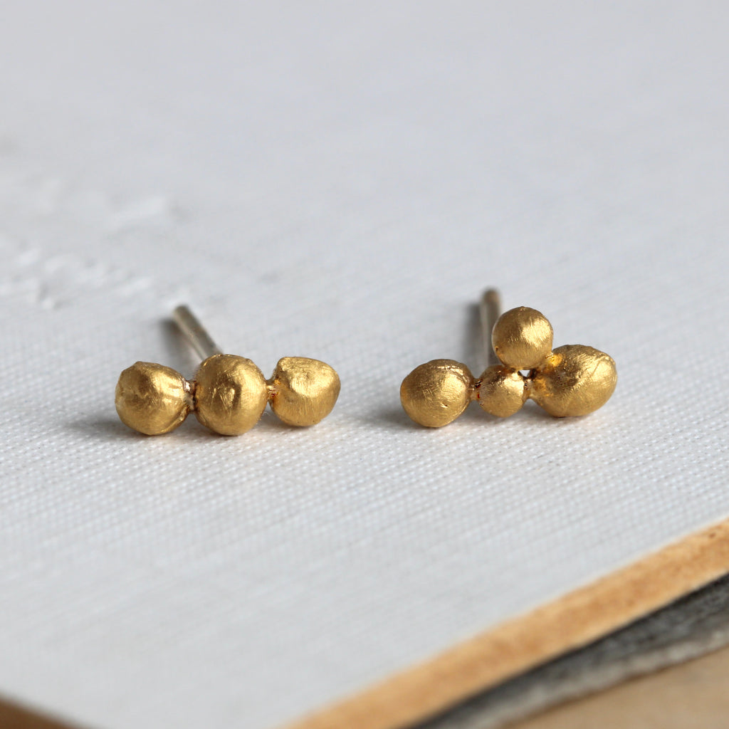 tiny pure gold balls grouped together to make stud earrings