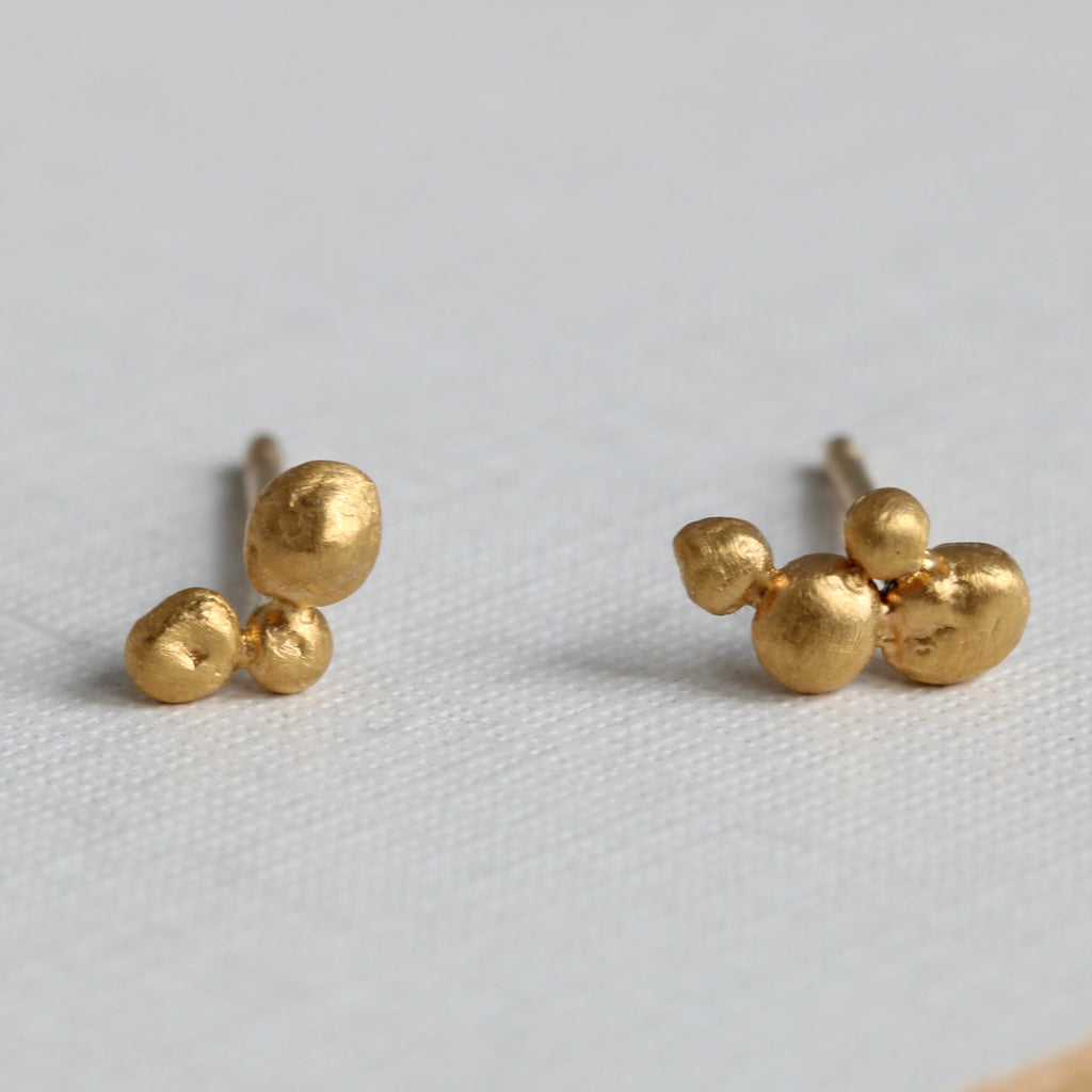 tiny 24k gold balls randomly grouped together to make stud earrings