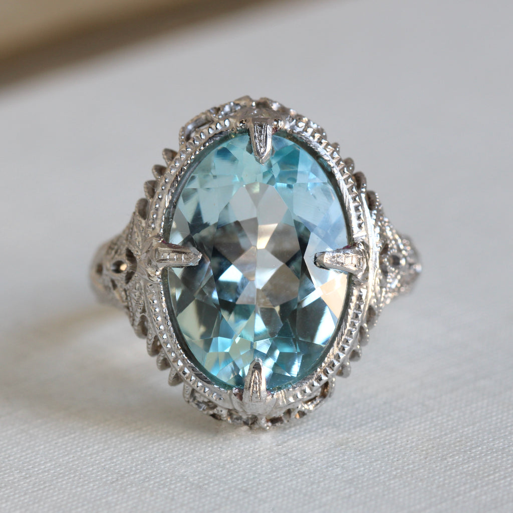 white gold filigree ring set with large oval sky blue topaz