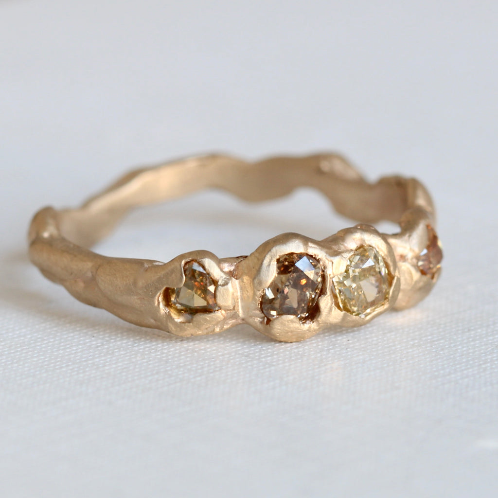 yellow gold band in undulating branch style set with natural spicy colored diamonds