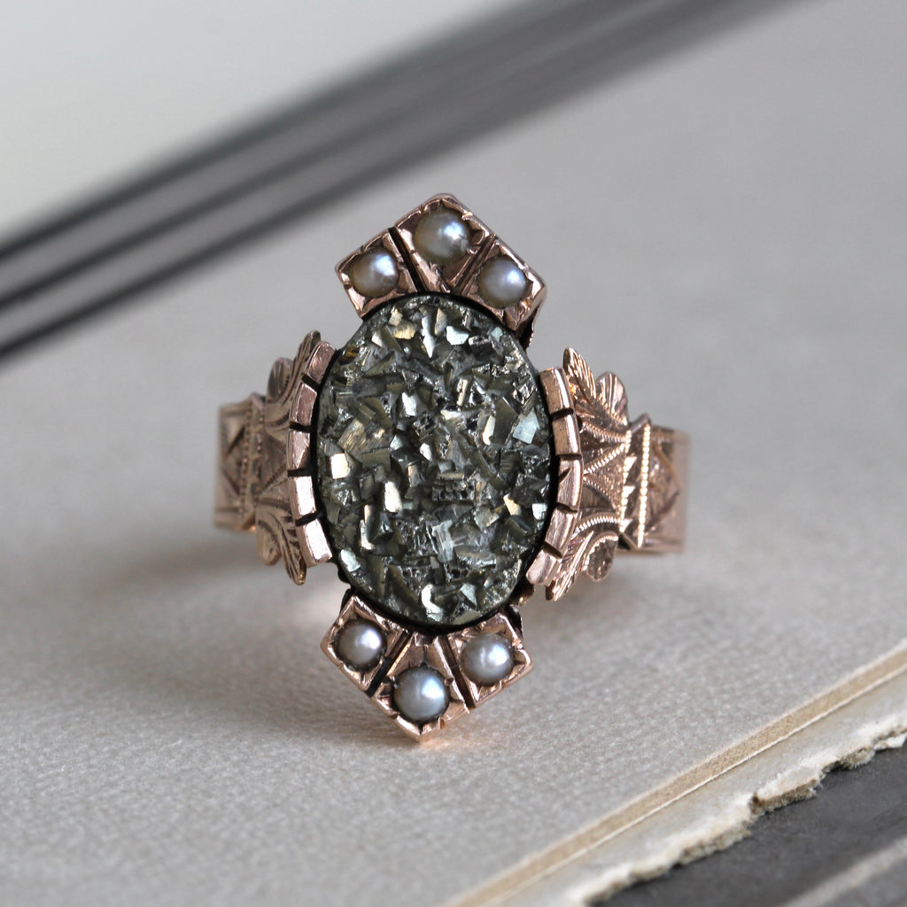 Antique 14k rose gold ring with a sparkling oval pyrite face accented by three creamy white pearls north and south on the bezel.