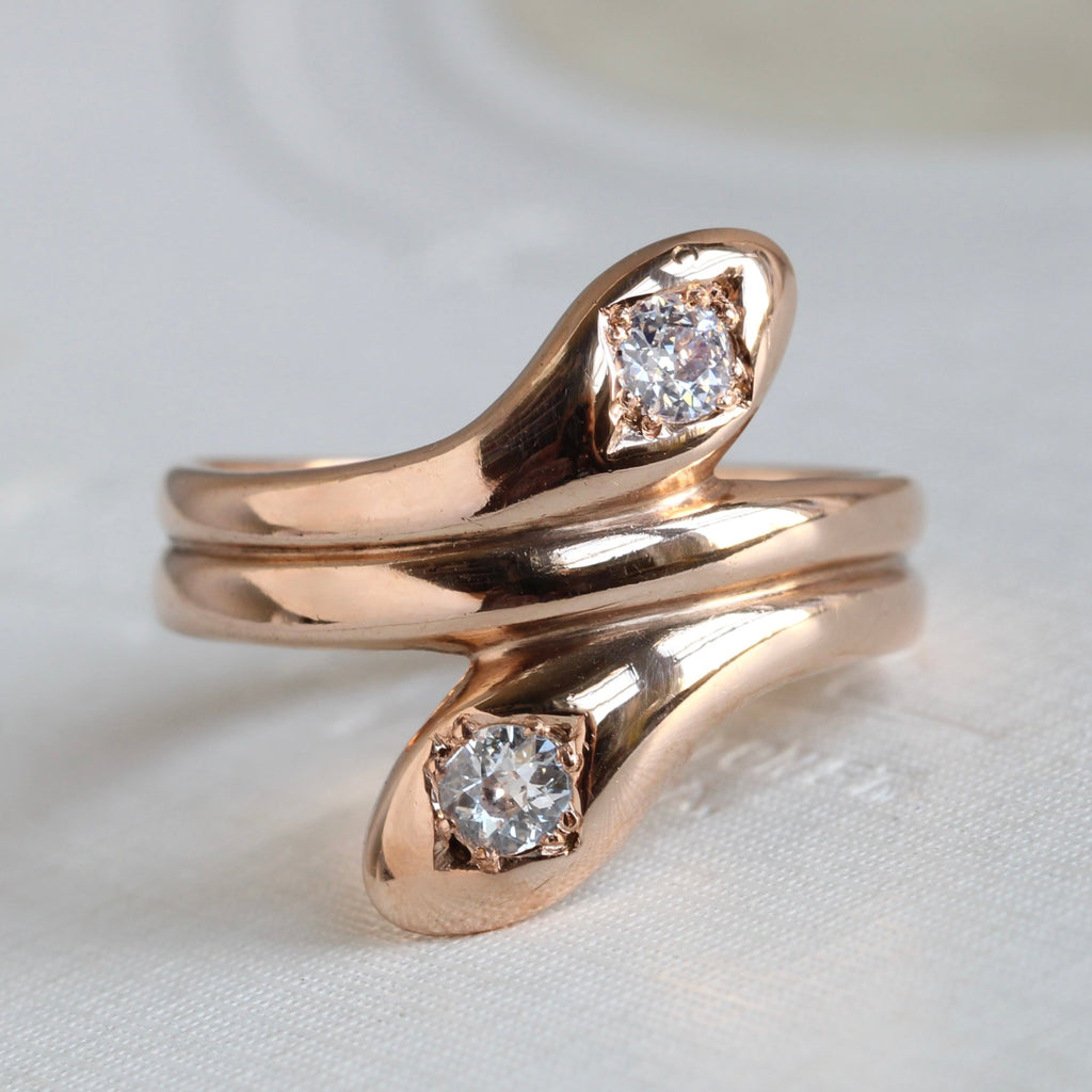 rose gold double snake ring with bright old cut diamonds set in their heads