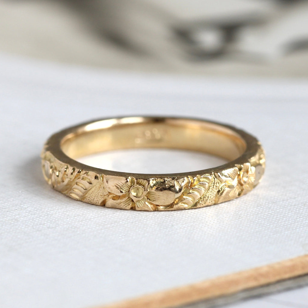 yellow gold band carved all around with daffodils and leaves