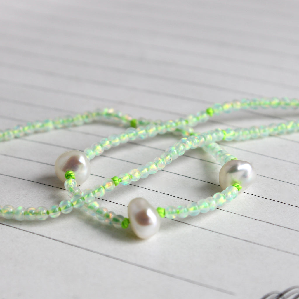 synthetic opal mini bead necklace knotted on green silk with three baroque pearl accents