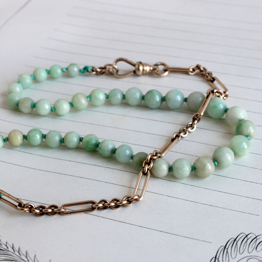 small light green jade ball bead necklace with a section of antique gold chain