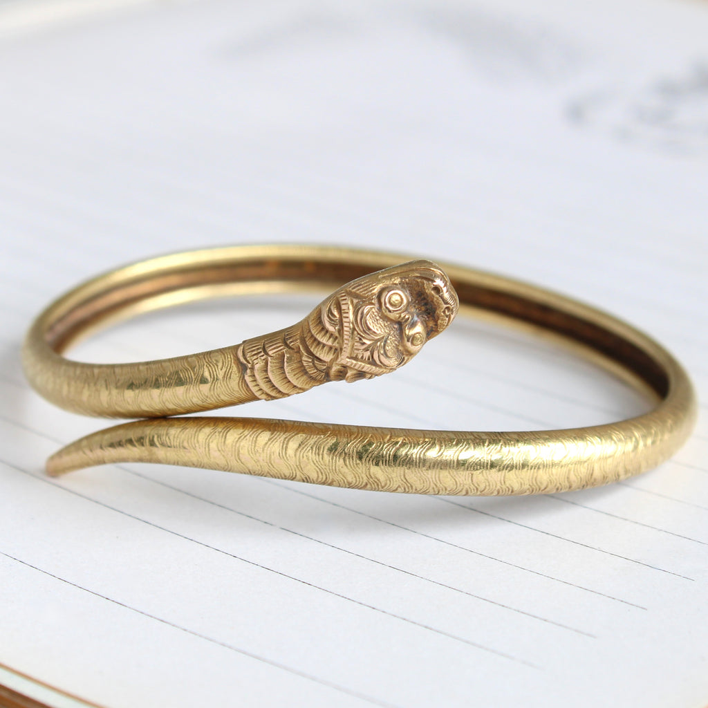 yellow gold bangle designed as a single coil snake 